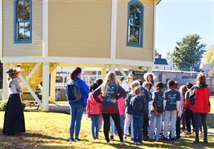 Students on walking tour by Roundhouse Railroad Depot in downtown Madison